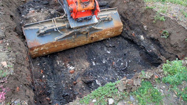 photo of tractor cleaning out soil