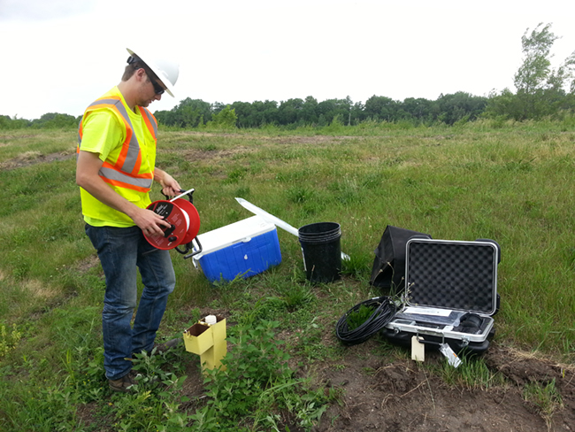 Tech outdoors doing a soil and groundwater investigation